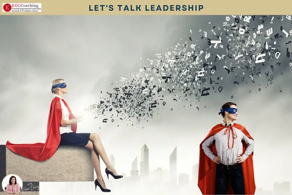 Two professionals wearing superhero capes, one seated and one standing confidently