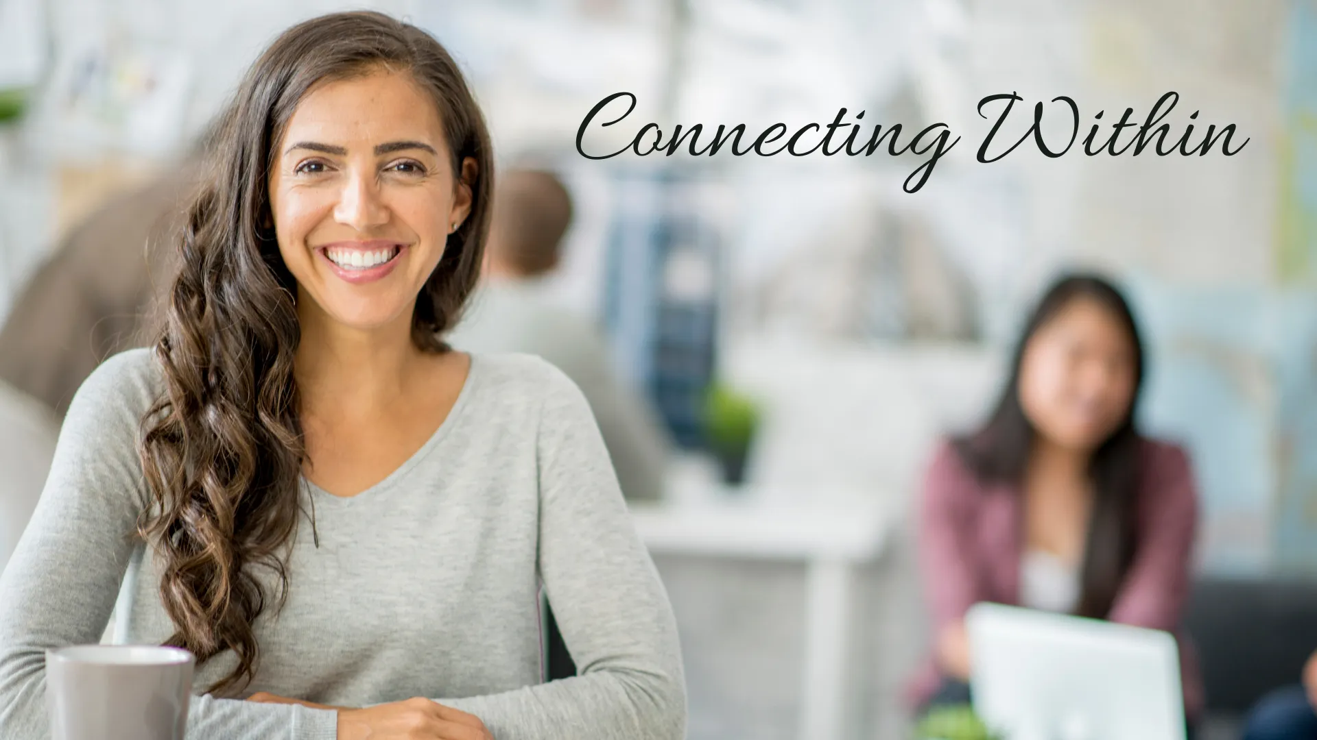 Smiling woman at work with the words: Connecting Within